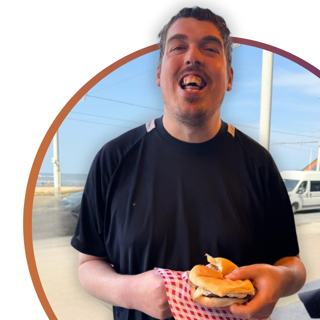 Alex enjoying time in Blackpool, smiling and relaxed while taking in the seaside surroundings.