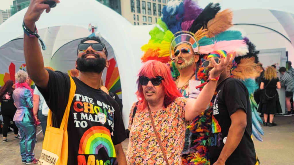 Client of Komplex Community smiling and enjoying Wolverhampton Pride 2025, dressed in bright rainbow colours, celebrating inclusivity, confidence, and personal growth in a vibrant Pride parade.