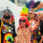 Client of Komplex Community smiling and enjoying Wolverhampton Pride 2025, dressed in bright rainbow colours, celebrating inclusivity, confidence, and personal growth in a vibrant Pride parade.